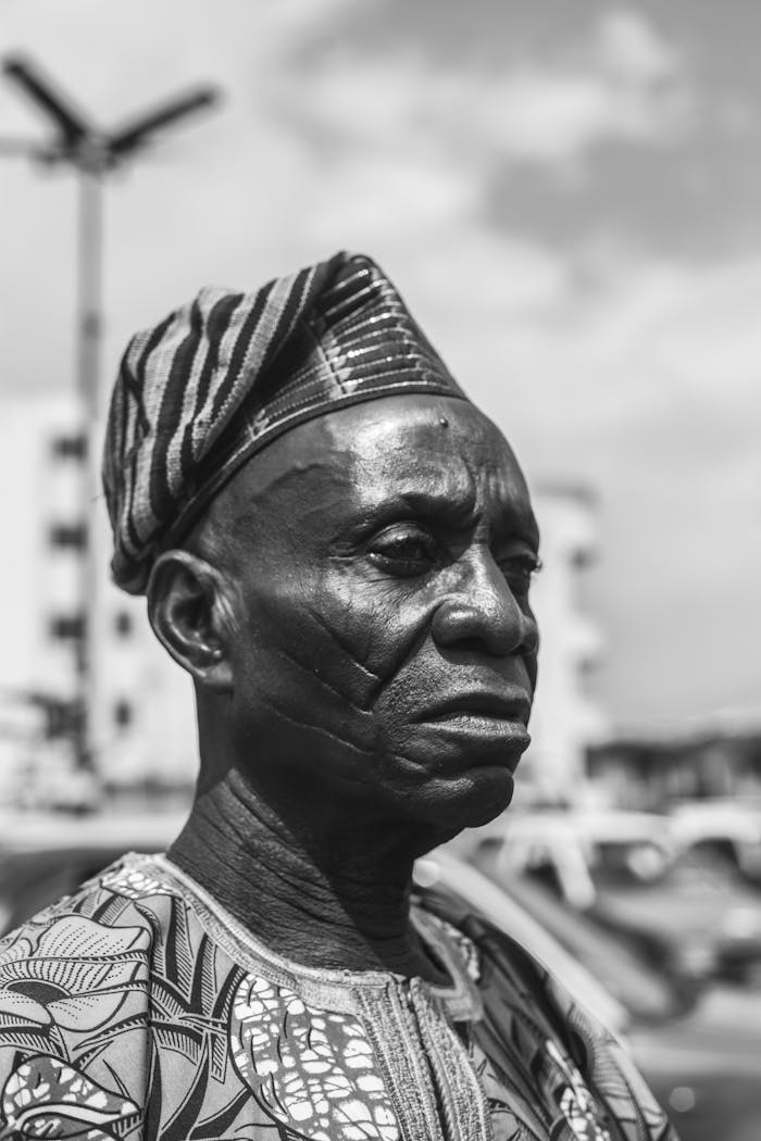 Black and white portrait of an African man in traditional attire, Ibadan, Nigeria.