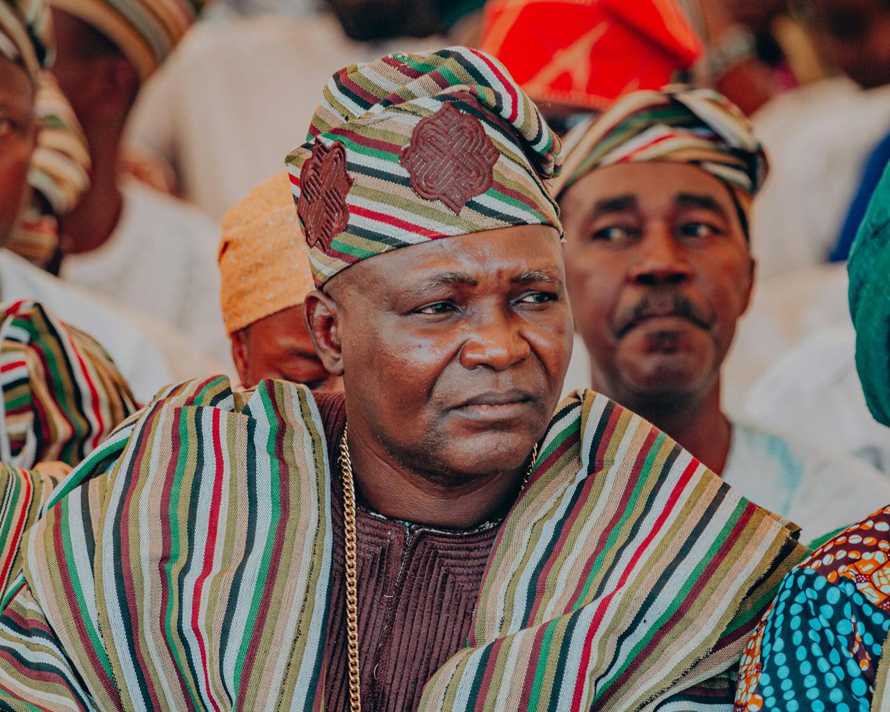 Portrait of a Nigerian man wearing colorful Yoruba traditional attire at a cultural event.