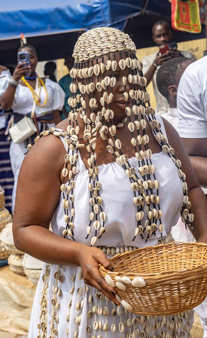 A woman in cowrie shell attire participates in a Yoruba festival in Osogbo, Nigeria.