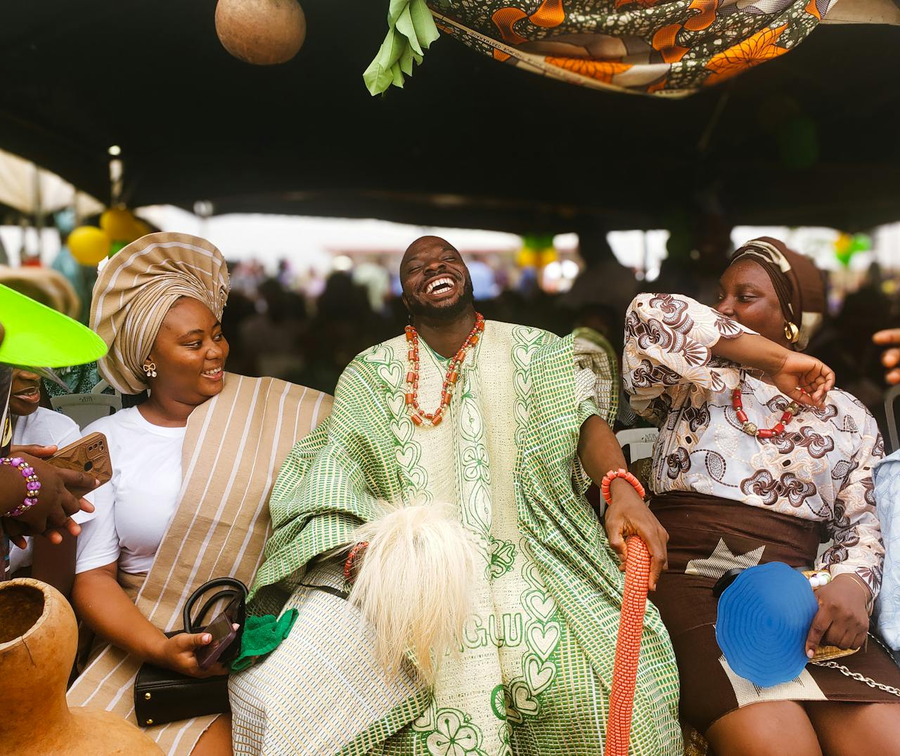 portfolio-04 Vibrant scene of Nigerians in traditional attire sharing joy at a cultural festival.