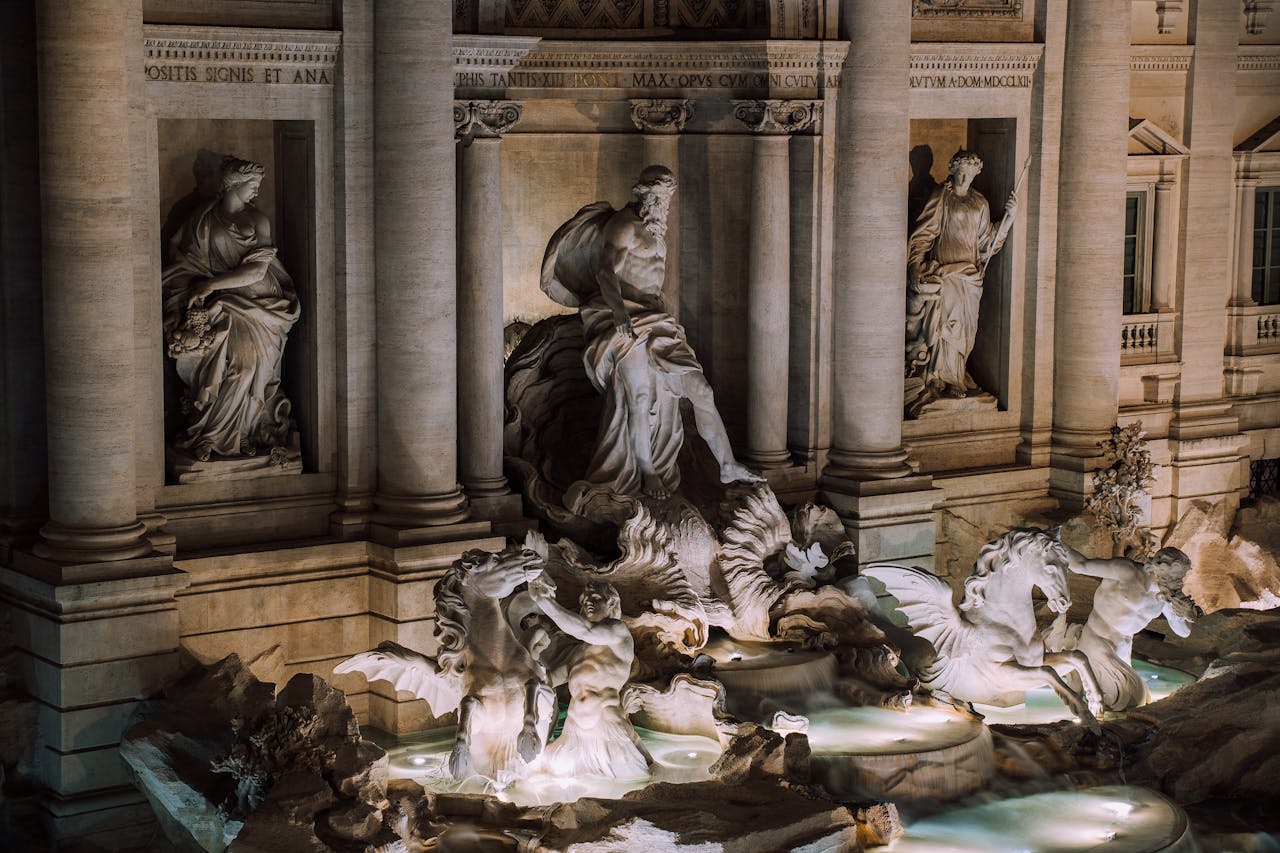 A stunning night view of the iconic Trevi Fountain in Rome, showcasing its intricate sculptures.